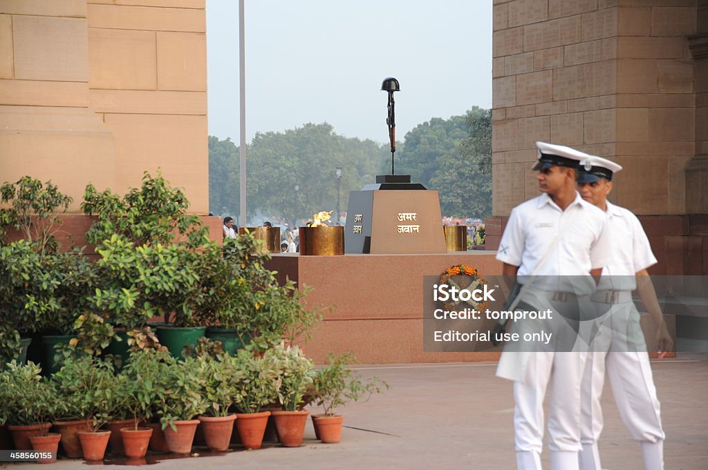 Tomb of the Unknown Soldier, New Delhi, India New Delhi, India - November 2, 2009: Two sentries stand guard at the Tomb of the Unkown Soldier in New Delhi, India. An eternal flame known as the Amar Jawan Jyoti (the flame of the immortal soldier) burns to honor India's war dead. Adult Stock Photo