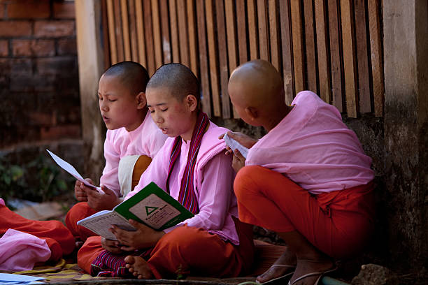 Yangon,  - February 24, 2011 : Two young female monks walking on the street in Yangon