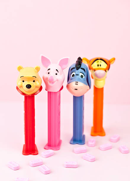 Winnie the Pooh Pez Characters Suffolk, Virginia, USA - May 2, 2011: A studio shot of a collection of Pez candy dispensers depicting characters from children\'s author A.A. Milne\'s Winnie the Pooh series. Pictured here, from front to back, are Winnie the Pooh, Piglet, Eeyore and Tigger. Focus is on Winnie the Pooh, while the other characters are defocused in the background. winnie the pooh photos stock pictures, royalty-free photos & images
