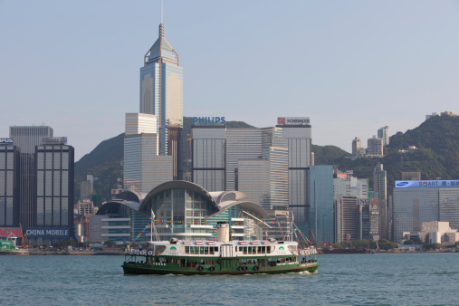 Hong Kong, China - April, 24th 2011: A Star Ferry at the Victoria Harbour. Star Ferry\\'s Harbour Tour plies its way between Hong Kong Island and Kowloon. This picture shows the SHINING STAR Star Ferry on Victoria Harbor, Hong Kong. Many tourists are on the ferry.