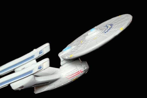Vancouver, Canada - December 11, 2011: The starship Enterprise from the Star Trek television franchise, against a black background. The model was made by Micro Machines, from Galoob.