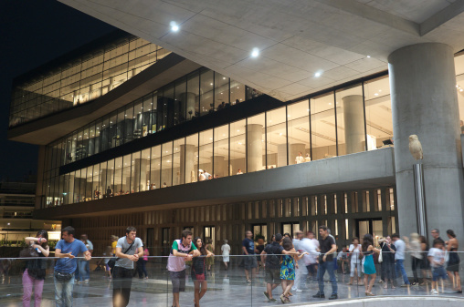 Athens, Greece - August 13, 2011: Exterior view of the Acropolis Museum with crowd of visitors. Athens celebrates August Full Moon on Saturday 13, 2011 with many cultural events. The museum was open until midnight with free entry for all visitors.