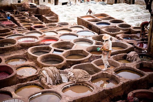 Fez, Morocco - September, 18 2008: people working in the medieval tannery located in the medina of Fes el Bali.