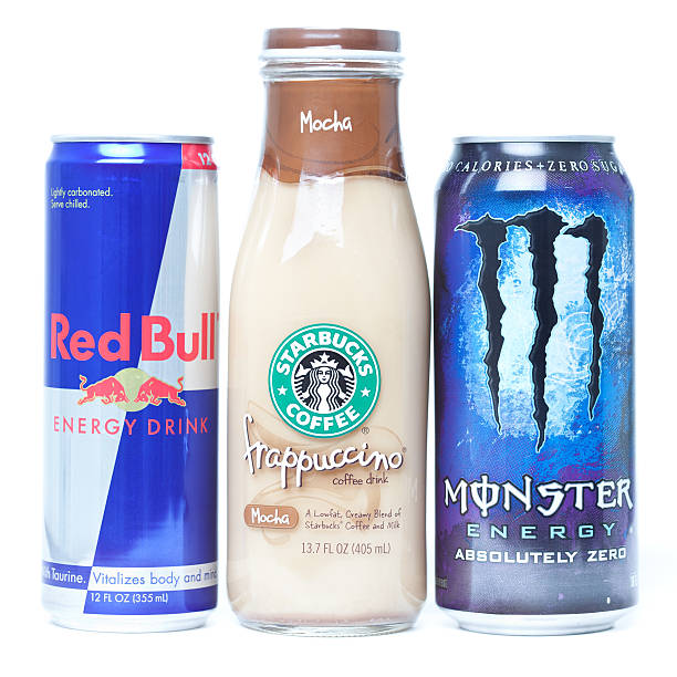 Energy Drinks Lined Up Fort Worth, TX, United States of America - May 2, 2011: Energy caffeinated drinks lined up. Red Bull, Starbucks coffee, and Monster Energy are all drinks that are commonly sold in the U.S.A. monster energy stock pictures, royalty-free photos & images