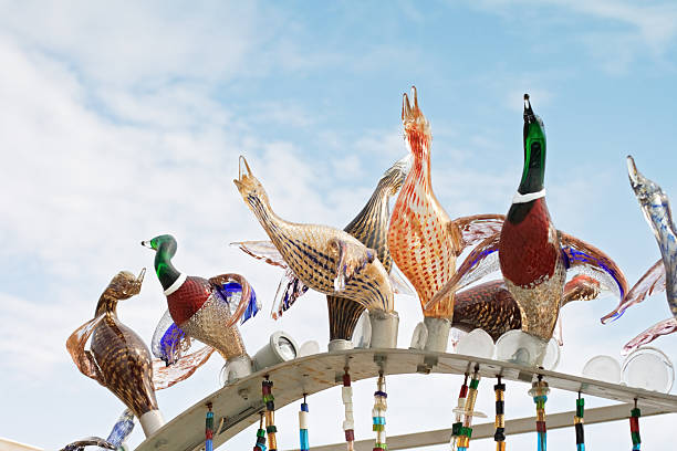 Venice, Italy - April 4, 2009: Colorful blown glass ducks isolated on blu sky in Fondamenta Lorenzo Radi in Murano, Venice