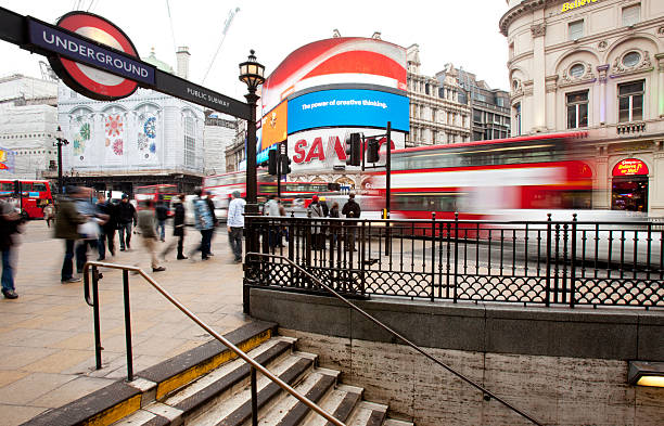 Piccadilly Circus, London. Piccadilly Circus, London, UK - December 22, 2010: Long exposure with blurred traffic and tourists rushing around one of the busiest areas in London. soho billboard stock pictures, royalty-free photos & images