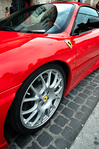 Saint Gotthard Pass, Switzerland - September 13, 2019: Red supercar Ferrari 458 Italia at the high mountain Alpine road.