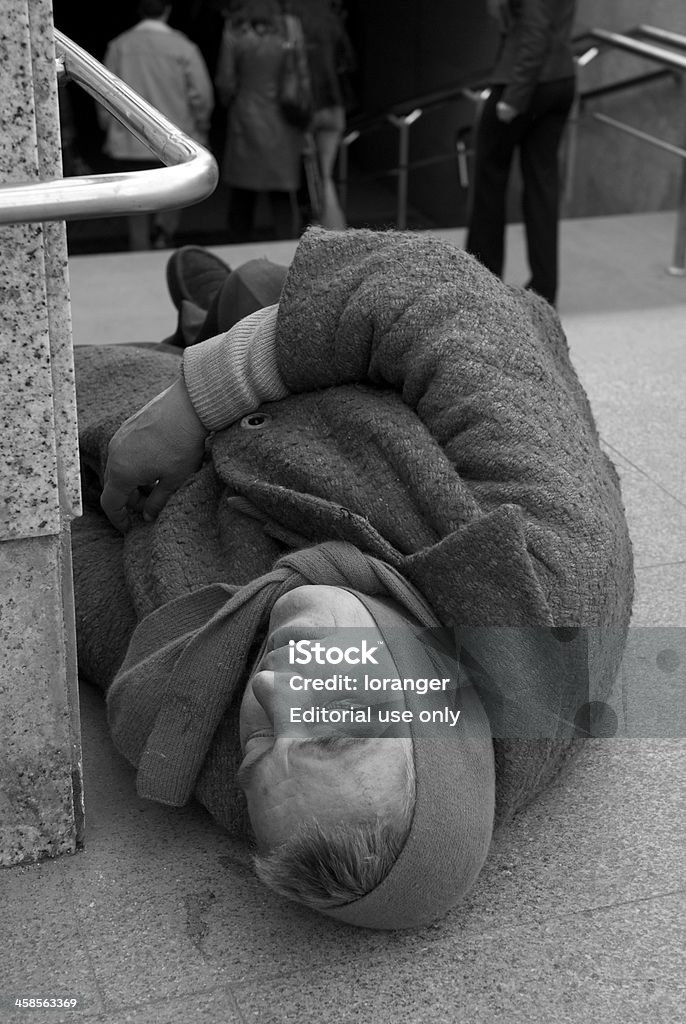 tramp Minsk, Belarus - April 16, 2007 :Homeless woman asleep on the staircase of the subway station in the centre of Minsk. Belarus Stock Photo