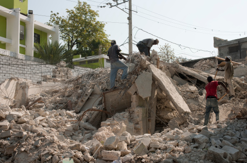 Port-au-Prince, Haiti, March 12, 2010: A group of man is searching in a collapsed building after victims of the earthquake in January.