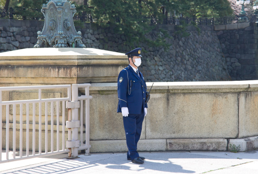 Tokyo, Japan - April 06, 2012: Policeman guarding the entrance to the Imperial Palace