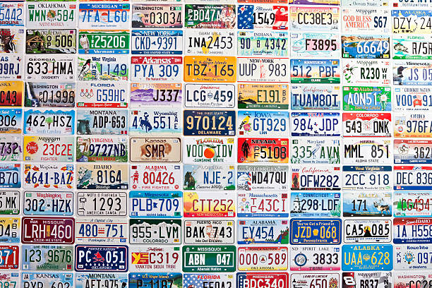 American License Plates New York City, New York - June 25, 2011: American license plates of various states on the outside wall of a gas station new york state license plate stock pictures, royalty-free photos & images