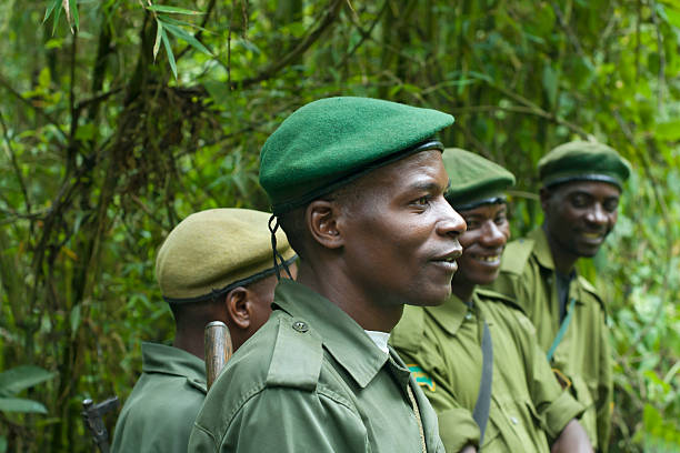 Group of National Park Rangers, Kahuzi Biega, South Kivu, Congo Kahuzi Biega National Park, Democratic Republic of Congo - October 25, 2007: A group of National Park rangers in the uniform of the National Park Rangers of Kahuzi Biega National Park. They just have led a group of tourists to a family of Eastern Lowland Gorillas. Kahuzi-Bi&Atilde;&copy;ga National Park is in eastern Democratic Republic of the Congo, 50 km west of the town of Bukavu in the Kivu Region, near to the western side of Lake Kivu and the Rwandan border. The park is one of the last refuges of the rare Eastern Lowland Gorilla. lake kivu stock pictures, royalty-free photos & images