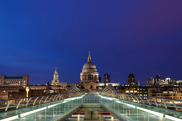 St. Paul's Cathedral and the Millennium bridge, dusk, London stock photo