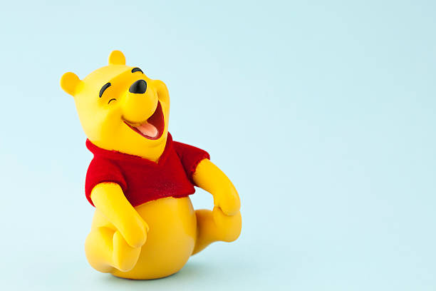 Winnie the Pooh Suffolk, Virginia, USA - April 21, 2011: A horizontal studio shot of the Disney character Winnie the Pooh shot on a blue background. Winnie the Pooh was originally created by English author A.A. Milne. winnie the pooh photos stock pictures, royalty-free photos & images