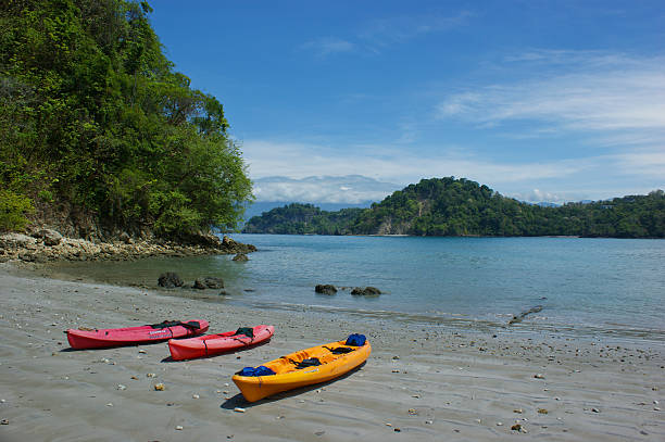 Kayaks on the Beach Manuel Antonio, Costa Rica - March 6, 2010: Kayaks sitting on the beach in Manuel Antonio, Costa Rica. manuel antonio national park stock pictures, royalty-free photos & images