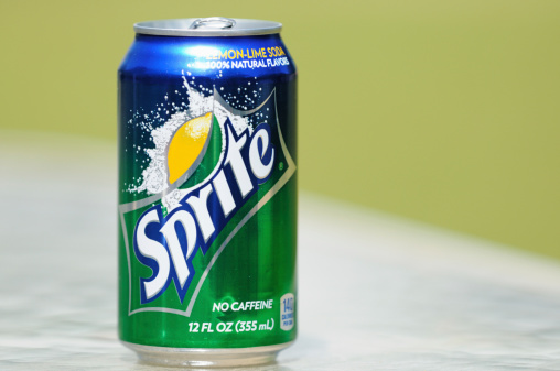 Northport, Alabama, USA - April 13, 2011: Close up of Sprite soda can in horizontal composition with out of focus background and copy space.  Aluminum can sitting on glass table.