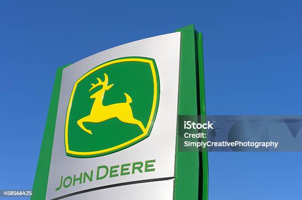 John Deere Sign Against Blue Sky Stock Photo - Download Image Now - John Deere, Agricultural Equipment, Agricultural Machinery