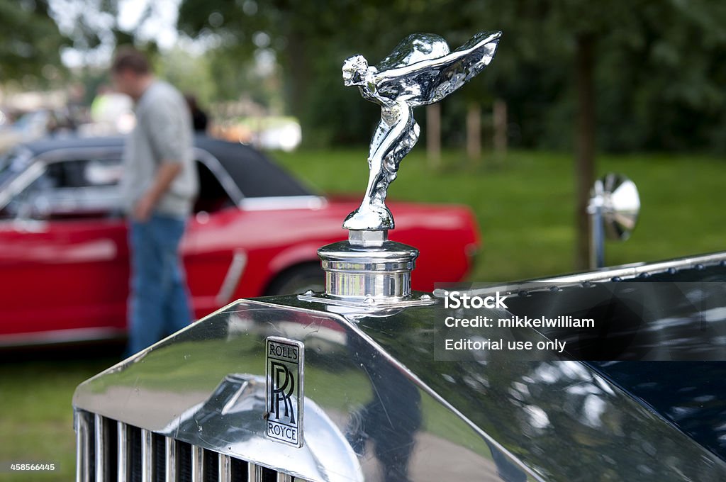 Rolls Royce Hood Ornament - Spirit of Ecstasy Copenhagen, Denmark - August 6th, 2011: Close up of the hood ornament of a classic Rolls Royce Phantom II Continental from 1933. The ornament also known as the Spirit of Ecstasy shows a woman leaning forward with her arms outstretched behind and above her. Her clothes are caught by the wind and resemble wings. The Spirit of Ecstasy was designed by Charles Robinson Sykes. 1933 Stock Photo