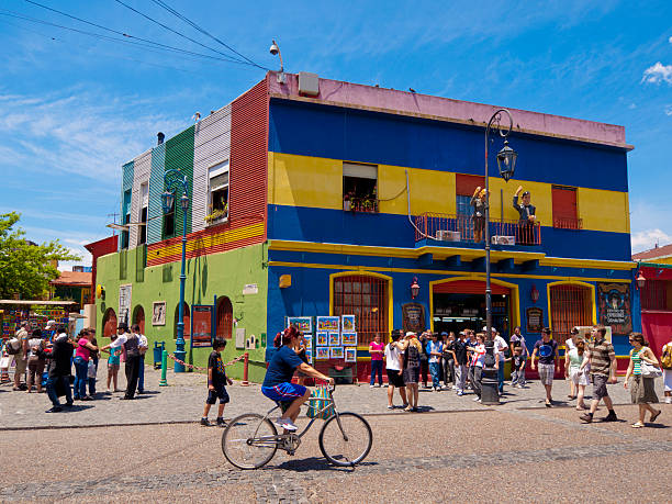 Colourful buildings, La Boca in Buenos Aires Buenos Aires, Argentina - December 15, 2009: Colourful building in the famous district of La Boca in Buenos Aires - many people can be seen on the street, including some street performers. la boca photos stock pictures, royalty-free photos & images