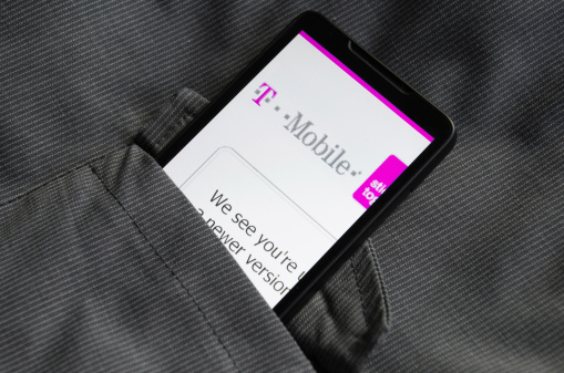 Florence, Italy - May 9, 2011: Smart phone with T-mobile.com web pages inside the pocket of jacket. The smart phone is an HTC HD2 Leo. The browser of the phone is Internet Explorer for windows mobile. T-mobile is a german Mobile Telecommunication firm.