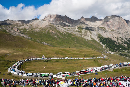 Col du Galibier, France - July 21, 2011: Spectators, cyclists, campervans and team buses line the roads at the bottom of the Col du Galibier in preparation for stage 18 of the 2011 Tour de France