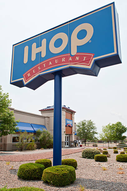 International House of Pancakes - IHOP Restaurant Albuqerque, New Mexico, USA - July 2, 2011: Side view and a pole sigh of the IHOP Restaurant in North East Albuquerque. The International House of Pancakes, also known as IHOP is a United States-based restaurant chain that specializes in breakfast foods such as pancakes, French toast and omelettes. Ihop stock pictures, royalty-free photos & images