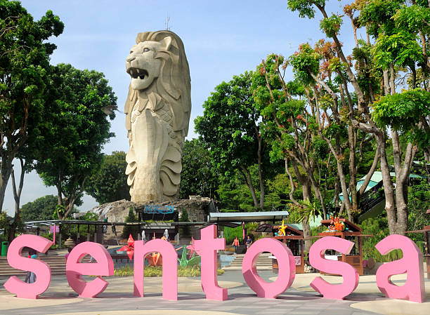 Sentosa, Singapore - March 28, 2011: The Merlion Statue. The Merlion is one of the national emblems of Singapore and is is a mythical creature, half fish and half lion, This example is situated on Sentosa Island and is a 37 metre high replica of the original statue located on the Singapore waterfront. It has become a popular attraction for tourists who can climb to the top for a panoramic view of the island.
