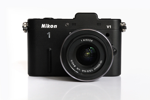 Kampen, The Netherlands - January 26, 2012: Nikon V1 mirrorless digital camera with interchangeable lens isolated in a studio.