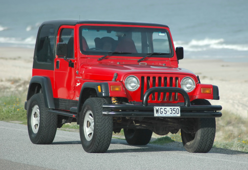 Adelaide, South Australia - July 29, 2009: Red TJ 1997 Jeep Wrangler hardtop on street at beach. This model wrangler is always in demand and holds it\'s value as a used 4x4. Particularly the hard top version. Manufactured between 1996 and 2006