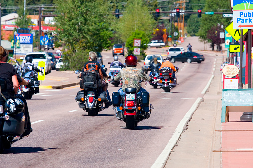 Woodland Park, Colorado, USA - July 24, 2011: Bikers head west on Highway 24 through downtown Woodland Park, Colorado for the Poker Run Bike Rally