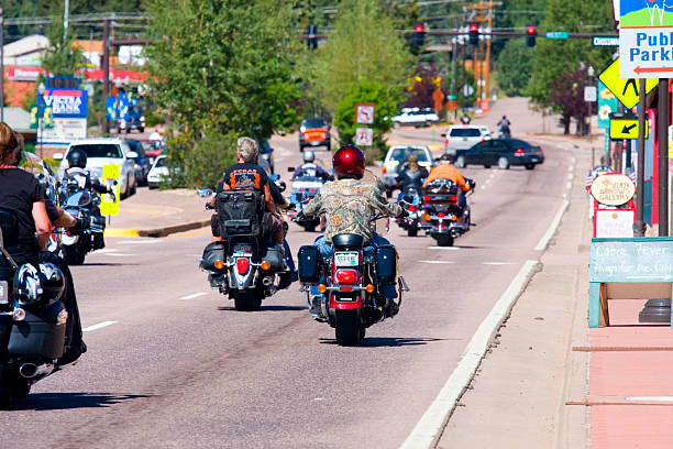 Poker Run Bike Rally Woodland Park, Colorado, USA - July 24, 2011: Bikers head west on Highway 24 through downtown Woodland Park, Colorado for the Poker Run Bike Rally woodland park zoo stock pictures, royalty-free photos & images