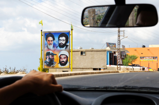 Qana, Lebanon - September 2, 2010: A roadside display of several important Shiite figures near the town of Qana in southern Lebanon. The portraits include the Ayatollah Khomeini of Iran (upper left); Abbas al-Musawi, who was Secretary General of Hezbollah until his assassination in 1992 (upper right), and Imad Mughniyah, a Hezbollah leader assassinated in 2008 (lower left).