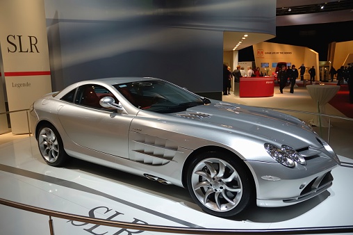 Amsterdam, The Netherlands - February 9, 2005: Silver Mercedes McLaren SLR on display at the 2005 Amsterdam Motor Show. People in the background are looking at the cars.