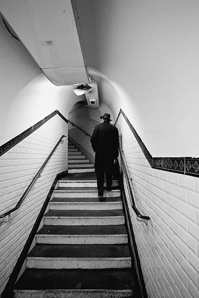Paris, France - January 18, 2012: Man walking in one of the tunnels of the Paris Metro. The network has sixteen lines that runs to 214km in length.