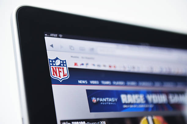 iPad Displaying the NFL Logo and Web Site Raleigh, NC - USA - June 27, 2011: Woman Holding an iPad Displaying the NFL Logo and Web Site. how to sell my photography online stock pictures, royalty-free photos & images