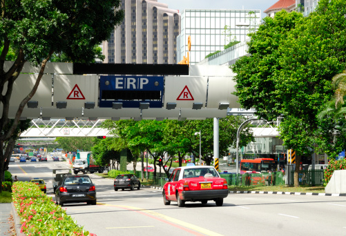 Singapore City, Singapore - March 23, 2011: Newbridge Road, Singapore. The image shows an Electronic Road Pricing (ERP) gantry in Newbridge Road. The Singapore Land Transport Authority uses road pricing to manage traffic flows into the downtown district of Singapore during peak periods, Over 80 such gantries exist have been built around the city. The system was first  implemented in 1998.