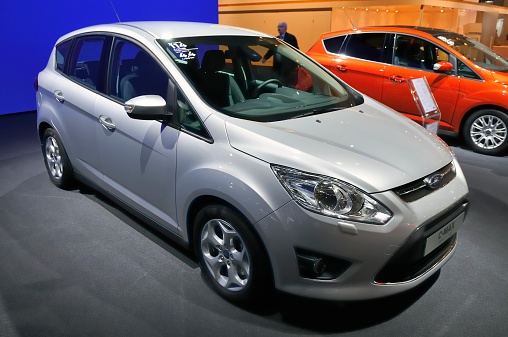 Brussels, Belgium - January 10, 2012: Silver Ford C-Max family car on display during the 2012 Brussels motor show. People in the background are looking at the cars.