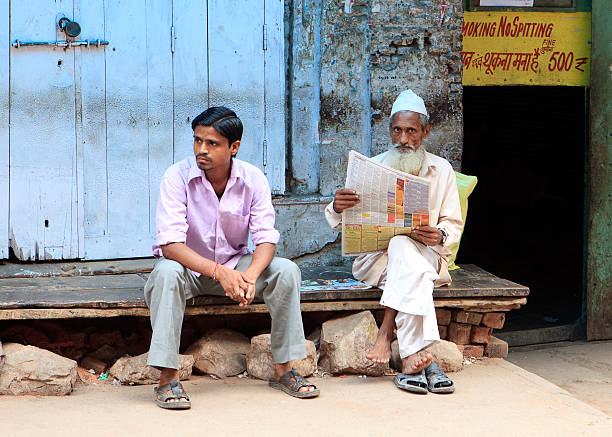 Market in Old Delhi New Delhi, India - July 16, 2011: Two store clerks waiting for any sign of activity in the early morning business day. old delhi stock pictures, royalty-free photos & images