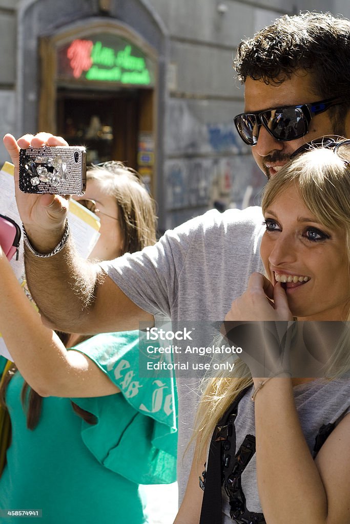 Boy and Girl Taking Photos With Cellphone Naples, Italy - October 1, 2011: Boy and Girl Taking Photos With Cellphone in the street of Spaccanapoli in Naples, Campania, Italy. 20-24 Years Stock Photo