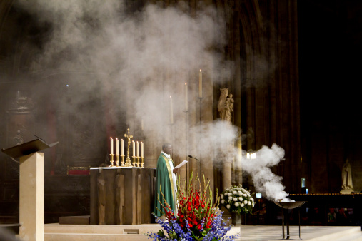 Paris, France - August 29, 2010: a photo of a catholic priest giving a mass inside Notre Dame cathedral in Paris.