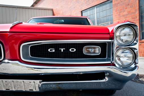Maryville, TN, USA -  May 12, 2011: The front grill of a beautifully-restored 1966 Pontiac GTO performance car.  While the Pontiac brand was closed down by General Motors during the Great Recession, in the 1960s Pontiac was the third best-selling brand in the United States after Chevrolet and Ford.  The high-performance Pontiac GTO was one of the company\'s most recognizable symbols and contributed to Pontiac\'s success in that highly-competitive decade.