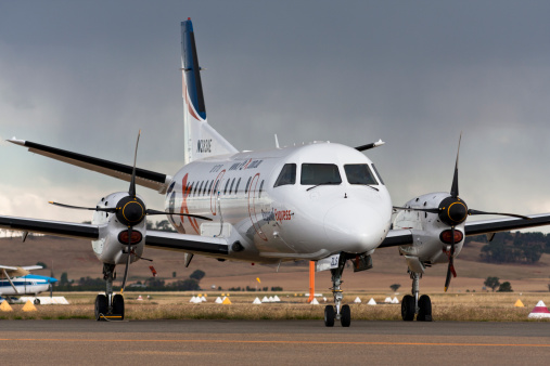 Wagga Wagga, Australia - November 27, 2008: Rex Regional express airline, a SAAB 340 at country NSW, parked and resting couple of hours before passengers boarding, with rain in the background.