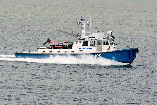 New York City Police Boat Speeding Through Harbor New York City, USA - June 14, 2011: New York City Police Boat "Det. Louis Lopez" Speeding Through New York Harbor columbus avenue stock pictures, royalty-free photos & images