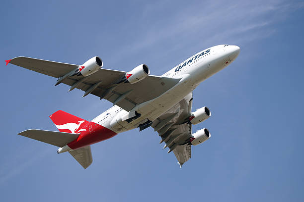 London Heathrow Airport, United Kingdom - May 4, 2011: World largest passenger aircraft Airbus A380 in Qantas color scheme (reg. VH-OQF) taking off at Heathrow Airport in almost cloudless sunny day. A380 maximum certified carrying capacity is 853 passengers. One of Qantas A380 powered with Rolls-Royce Trent 900 had an uncontained engine failure with structual damage and was forced to make emergency landing at Singapore airport.