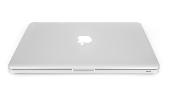 Merion, United States - March 11, 2011: A 2008 Apple Aluminum Unibody Macbook sits closed Isolated on a white background with a shadow.
