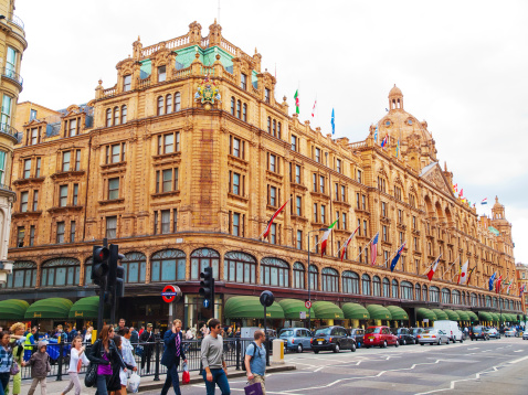 London, United Kingdom - May 21, 2009 : Front view of Harrods Building and the street full of people and cars