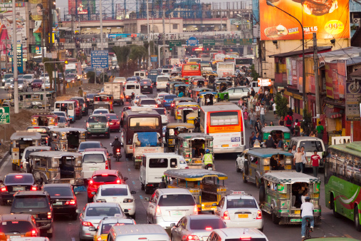 Manila, Philippines - April 19, 2012: Peak hour traffic in EDSA in the Passay district of Metro Manila. Many people can be seen amidst the traffic.