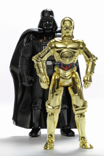 Vancouver, Canada - May 15, 2011: C3PO and Darth Vader toys from the Hasbro line of Star Wars toys, posed on a white background.
