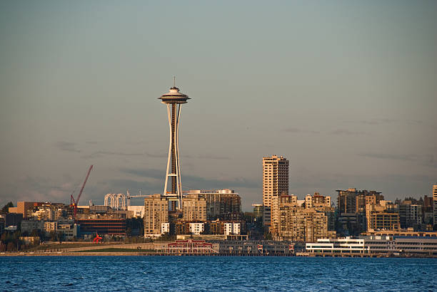 The Space Needle and Seattle Skyline at Dusk Seattle, Washington, USA - October 03, 2009: The Space Needle and Seattle Skyline are pictured at dusk in front of Elliot Bay. jeff goulden puget sound stock pictures, royalty-free photos & images