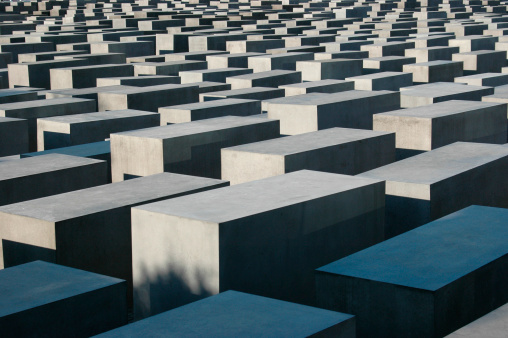 Berlin, Germany - June 19, 2005: A view on the Holocaust Memorial in Berlin. There are 2,711 concrete blocks. It reminds on the murdered Jews of Europe. It is located in the heart of Berlin.